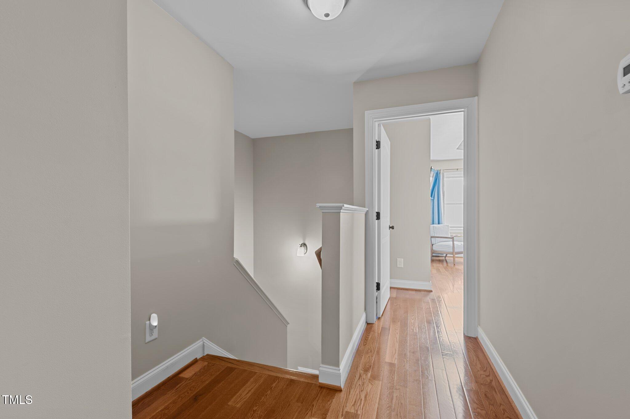 1036 Butterfly Circle Wake Forest, NC 27587 - Photo 45 of 51 a view of a hallway with wooden floor and staircase