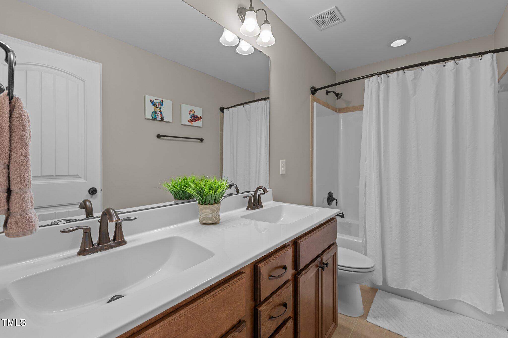 1036 Butterfly Circle Wake Forest, NC 27587 - Photo 48 of 51 a bathroom with a sink a vanity and a mirror