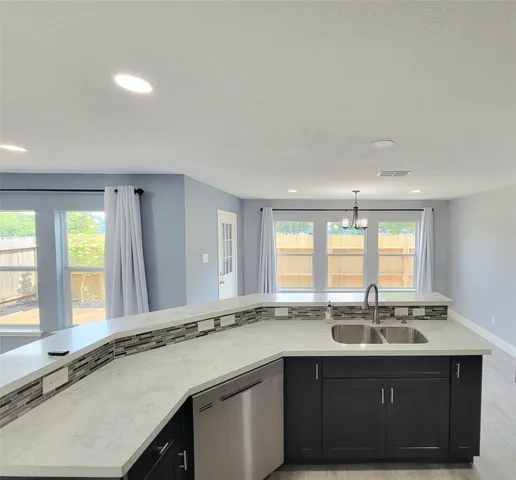 a kitchen with granite countertop a stove and cabinets