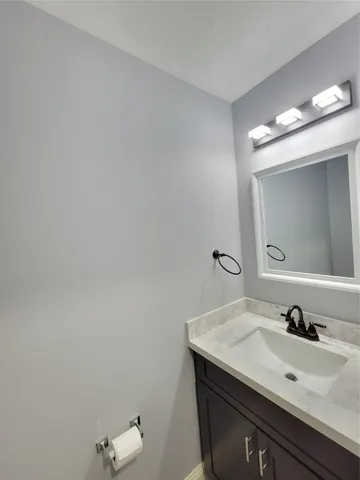 an empty room with windows and chandelier fan