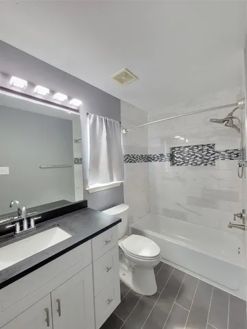 an empty room with a ceiling fan and a fan