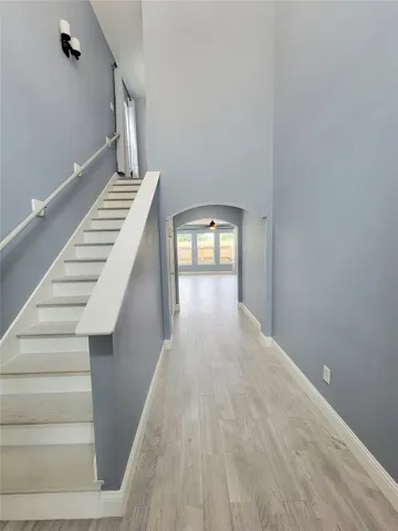 a view of empty room with window and ceiling fan