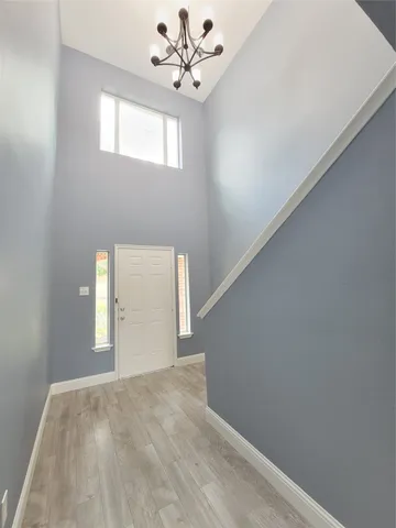 a view of an empty room with a window and fireplace