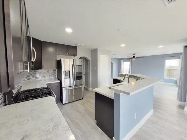 a kitchen with a sink and large window