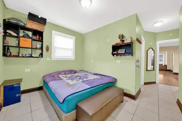 a bedroom with a bed and a painting on the wall