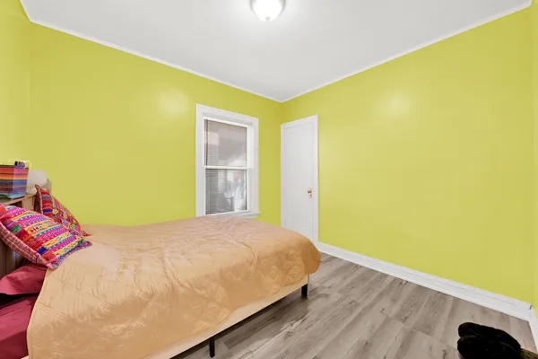 a bedroom with a bed and a large window