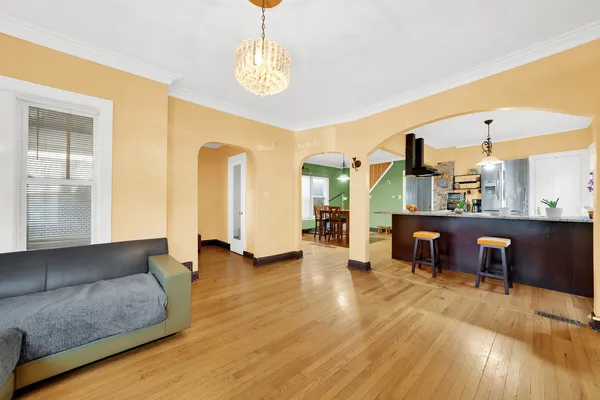 a living room with furniture and a chandelier