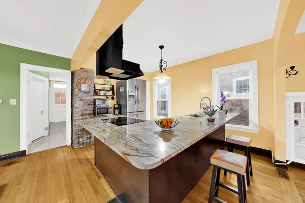 a living room with stainless steel appliances kitchen island granite countertop furniture and a kitchen view