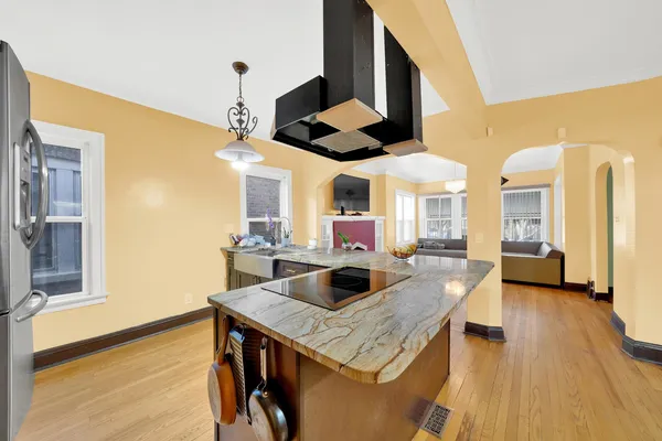 a kitchen with a stove and a wooden floor