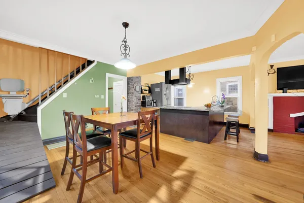 a view of a dining room with furniture and wooden floor