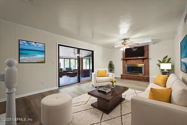 an empty room with wooden floor chandelier fan and windows