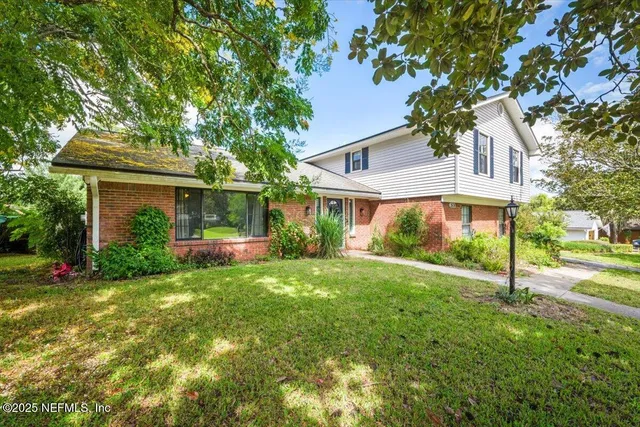 a front view of a house with a garden