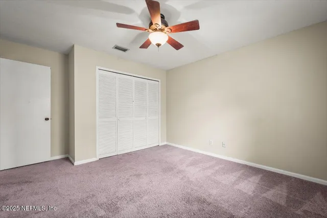 a bathroom with a granite countertop toilet sink and a mirror