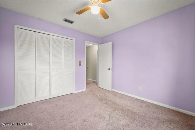 a living room with furniture and large windows