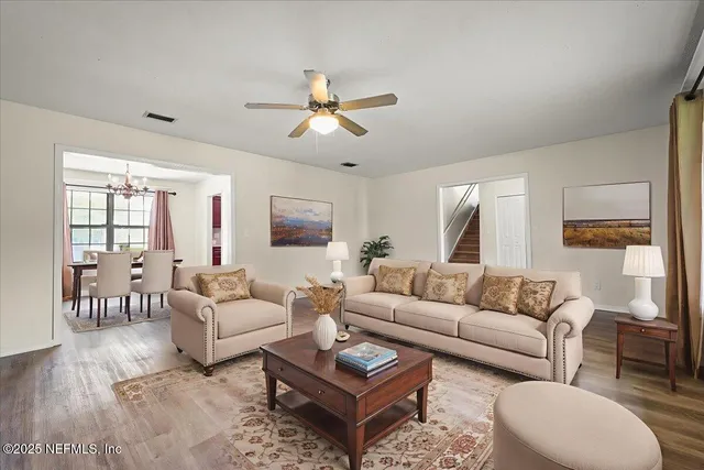a view of a dining room with furniture window and wooden floor