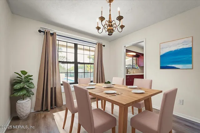 a kitchen with stainless steel appliances sink cabinets and wooden floor