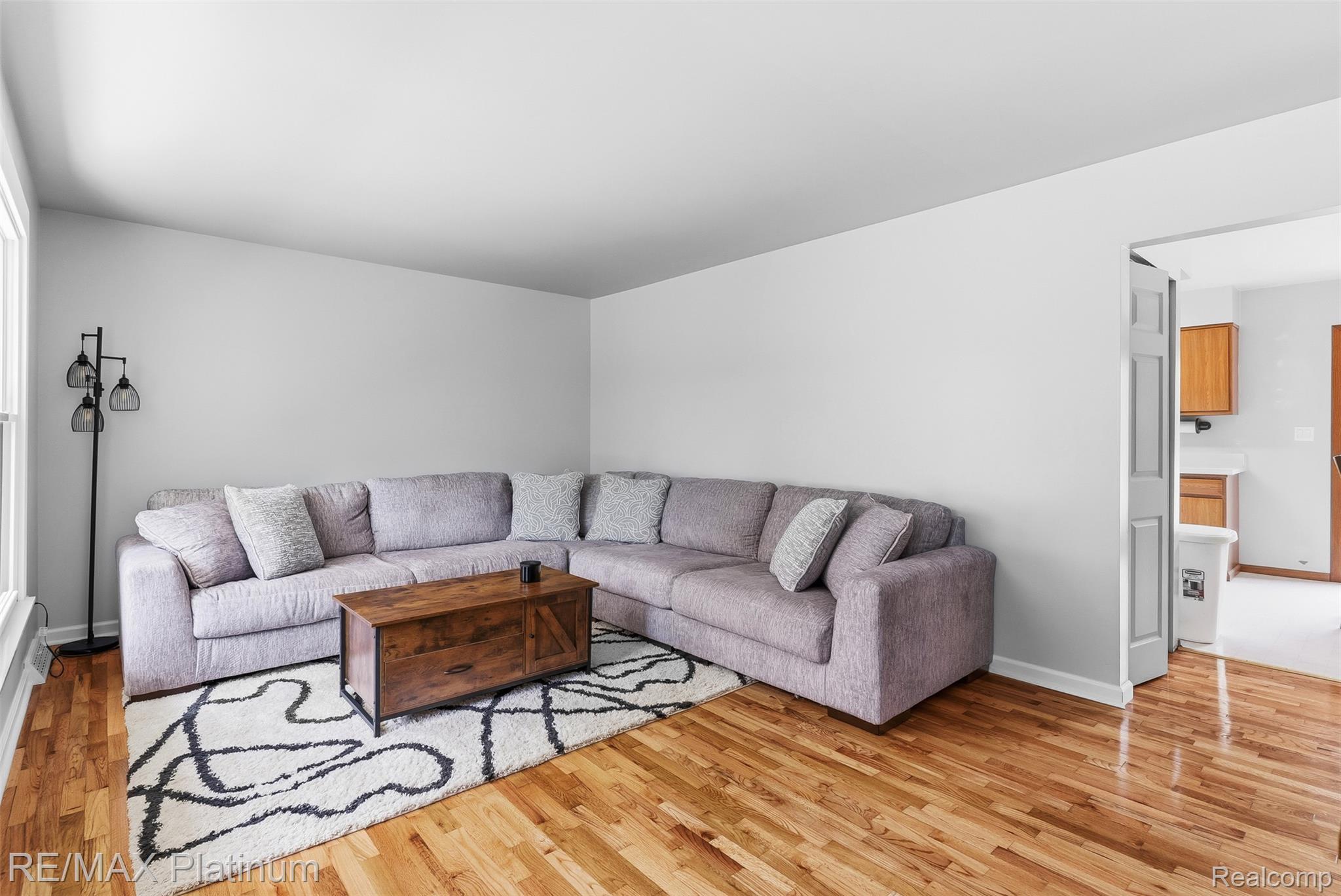 8370 West Rolston Road Linden, MI 48451 - Photo 5 of 36 Spacious living area featuring light wood-finish flooring, neutral wall tones, and an open doorway