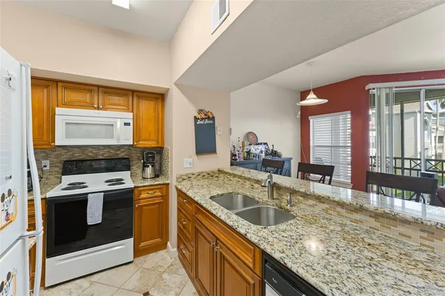 a kitchen with a stove sink and microwave