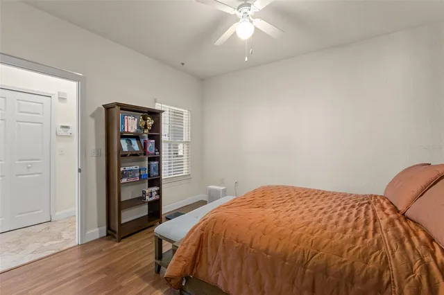 a spacious bedroom with a bed and a book shelf