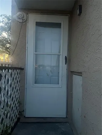 a bedroom with a bed and a flat tv screen on the dresser