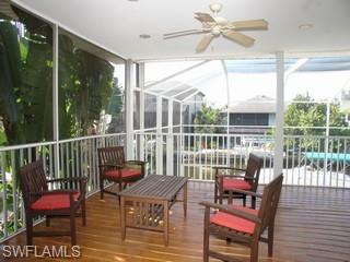 1283 Rainbow Court Naples, FL 34110 - Photo 6 of 8 a view of a chair and tables in the balcony