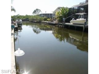 1283 Rainbow Court Naples, FL 34110 - Photo 7 of 8 a view of a house with a lake view