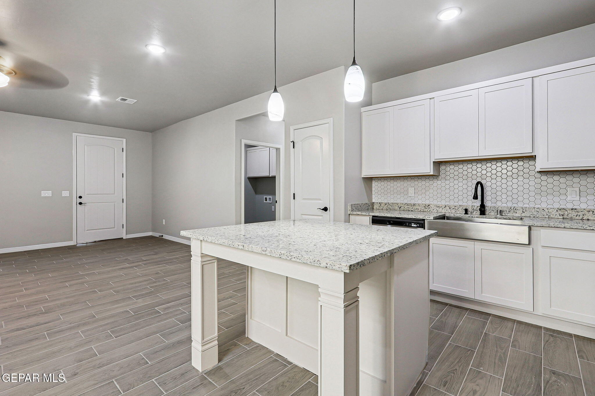 1153 Marquitos Avenue Anthony, NM 88021 - Photo 11 of 40 a kitchen with stainless steel appliances granite countertop a sink a stove and a refrigerator