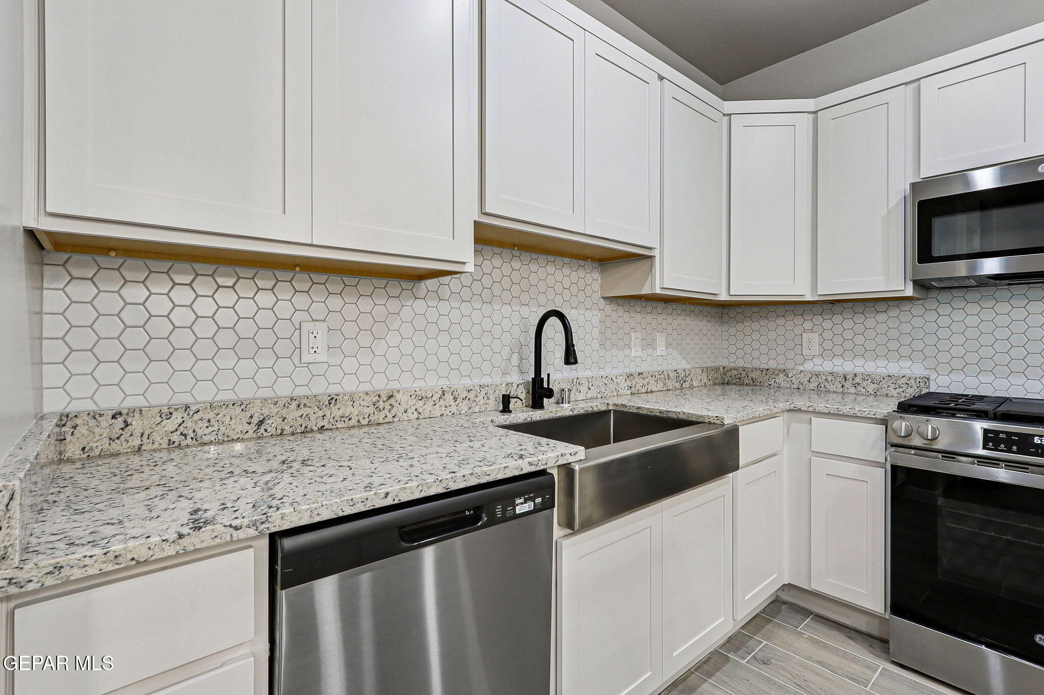 1153 Marquitos Avenue Anthony, NM 88021 - Photo 15 of 40 a kitchen with stainless steel appliances granite countertop white cabinets sink and dishwasher