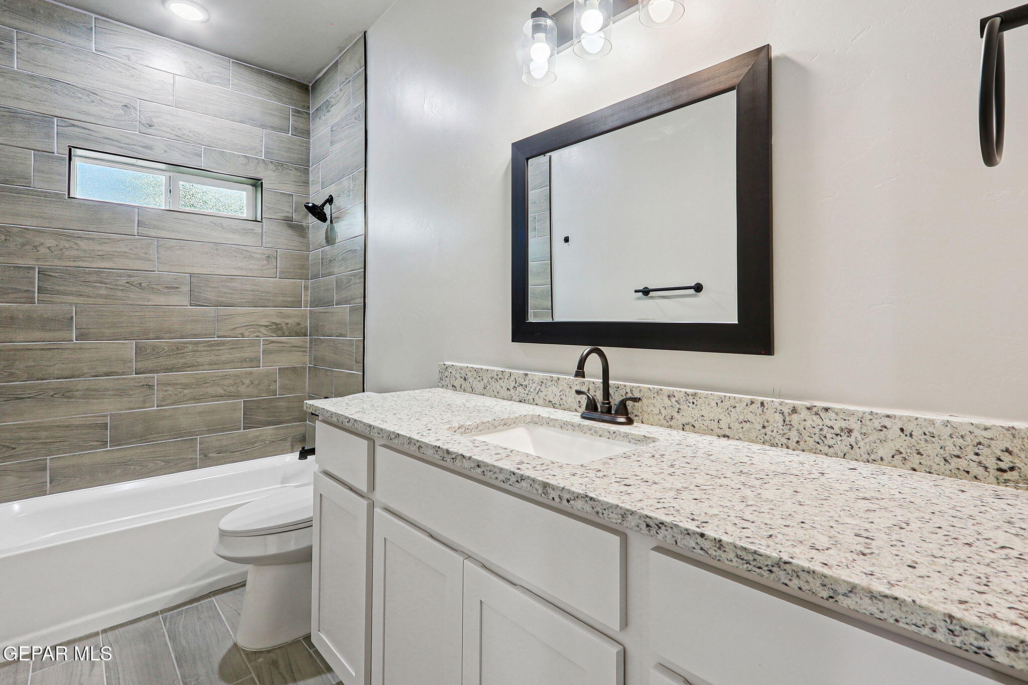 1153 Marquitos Avenue Anthony, NM 88021 - Photo 23 of 40 a bathroom with a granite countertop toilet sink and mirror