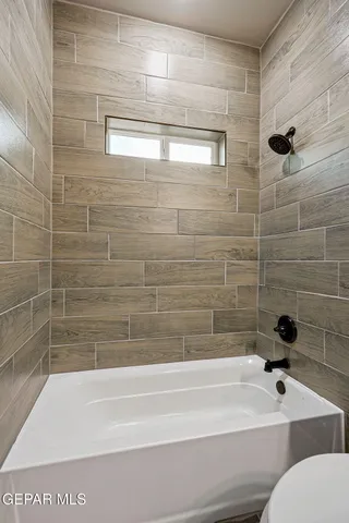 a bathroom with a bathtub and a shower