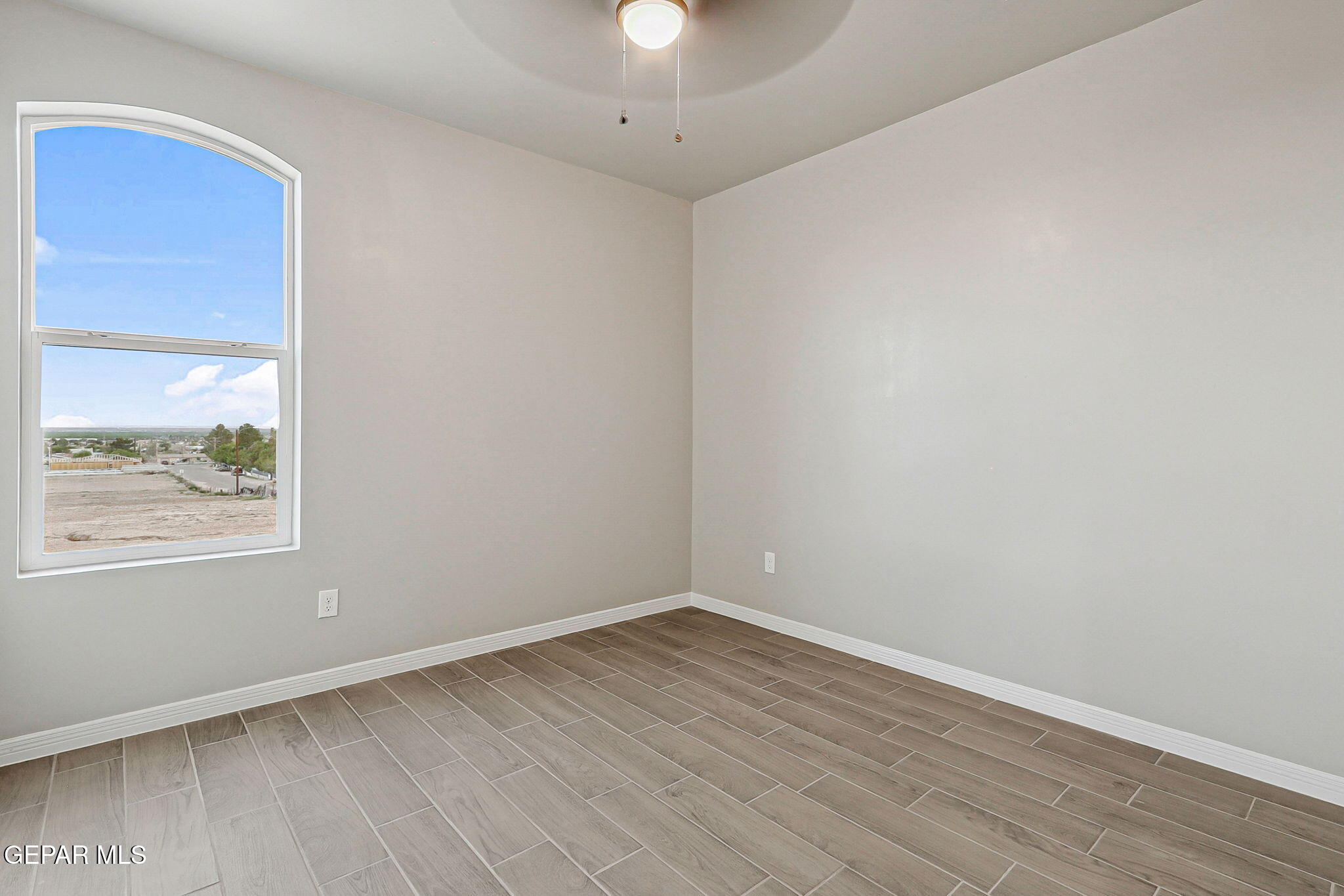 1153 Marquitos Avenue Anthony, NM 88021 - Photo 26 of 40 an empty room with a window and wooden floor