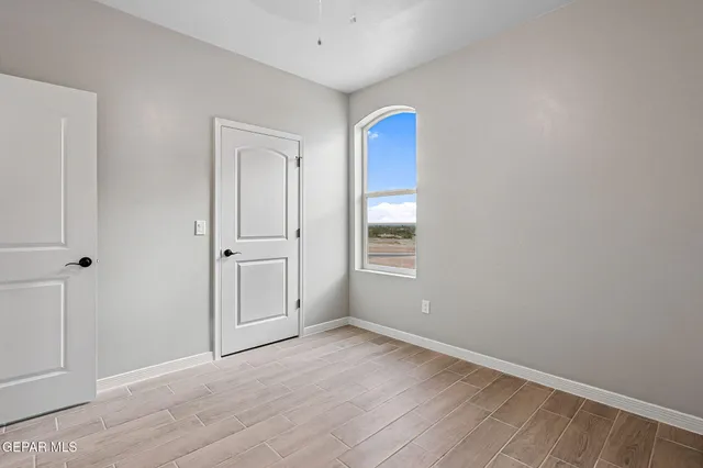 an empty room with windows and closet
