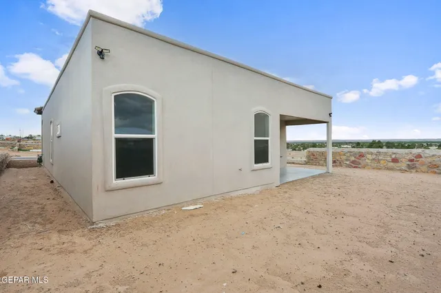 a view of an empty room with floor to ceiling windows