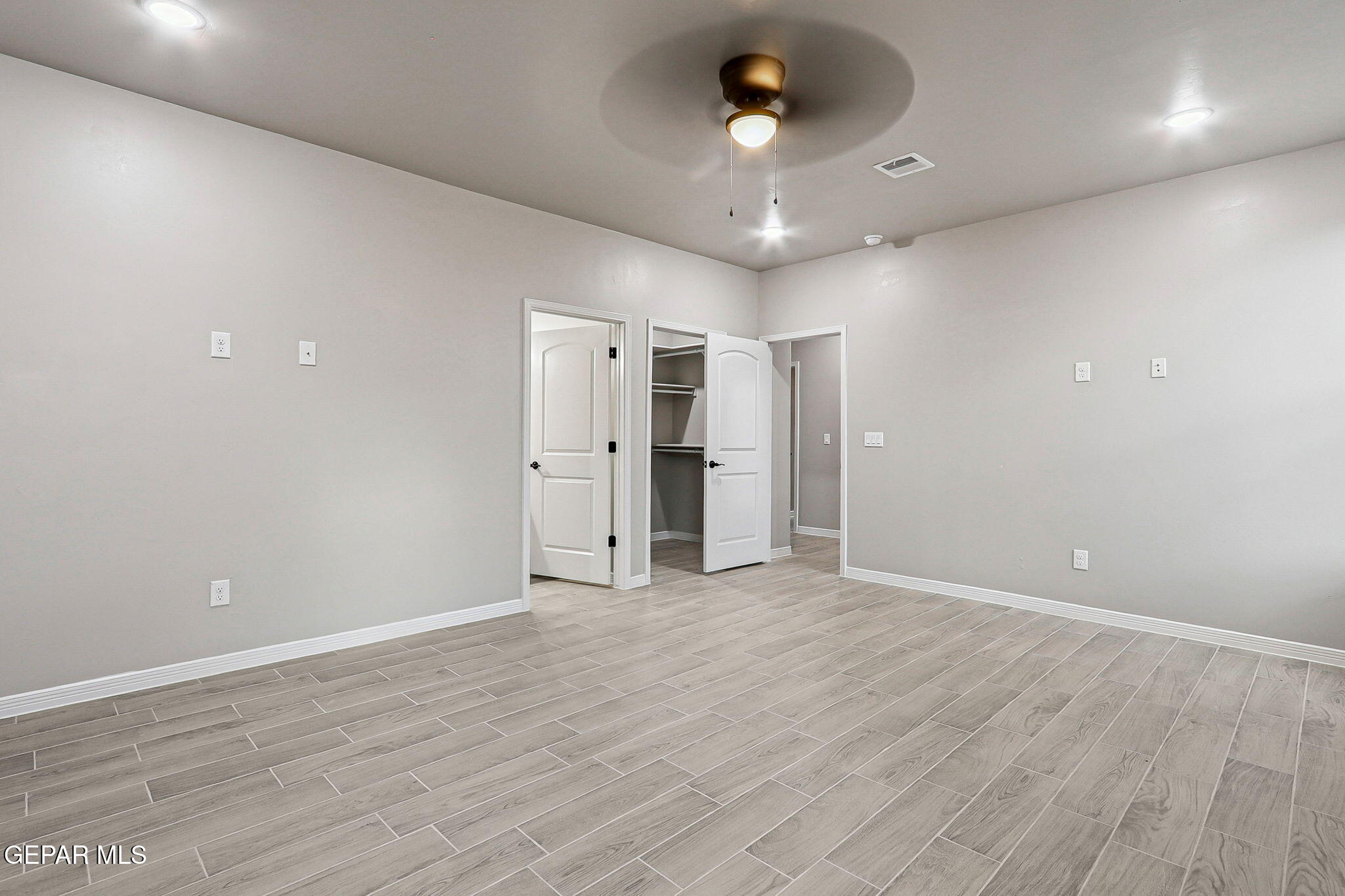 1153 Marquitos Avenue Anthony, NM 88021 - Photo 35 of 40 an empty room with wooden floor and a ceiling fan