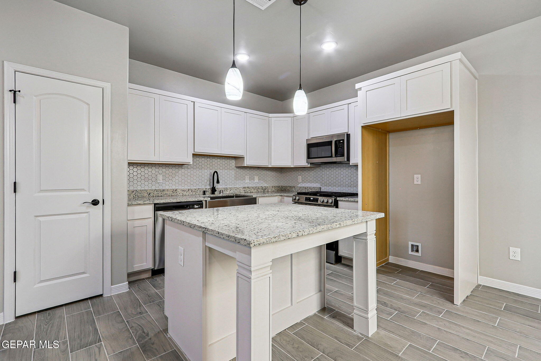 1153 Marquitos Avenue Anthony, NM 88021 - Photo 8 of 40 a kitchen with a stove a refrigerator and a sink