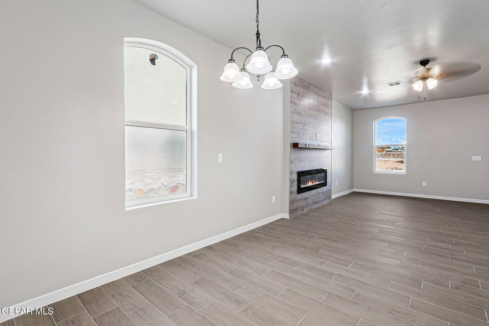 1153 Marquitos Avenue Anthony, NM 88021 - Photo 10 of 40 a view of an empty room with a window and wooden floor