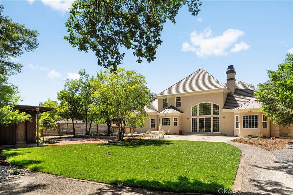 897 Filbert Avenue Chico, CA 95926 - Photo 52 of 66 a view of a white house with a big yard plants and large trees