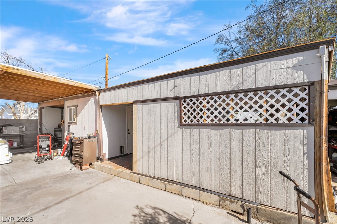 140 West Victory Road Henderson, NV 89015 - Photo 15 of 24 An ideal workshop or storage area featuring durable siding and an adjacent covered carport.