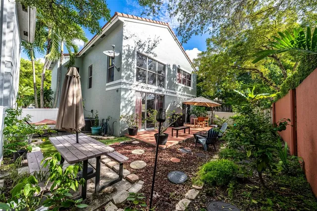 a view of a patio with table and chairs and potted plants