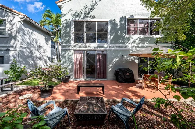a backyard of a house with yard and outdoor seating