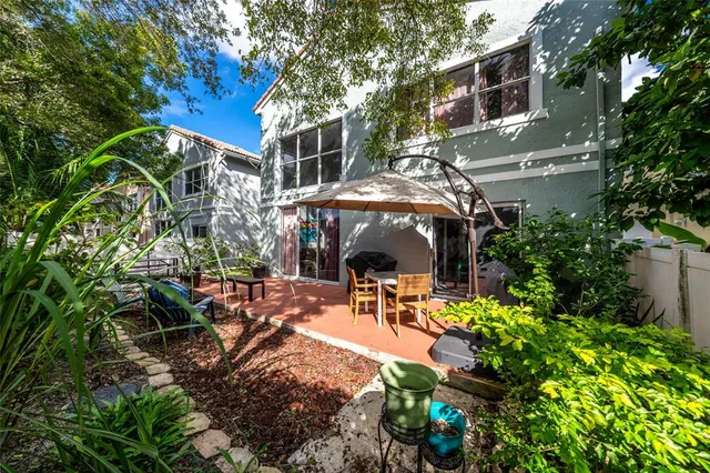 a view of a patio with table and chairs and potted plants