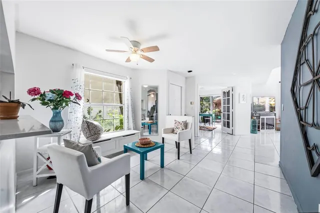 a living room with furniture and flowers
