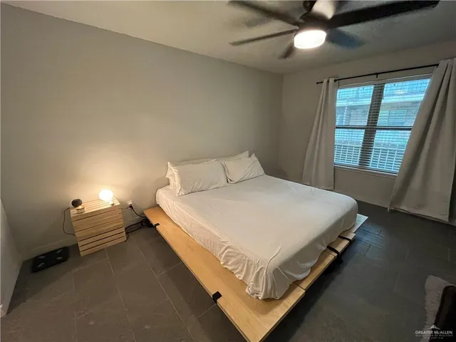 a bed sitting in a bedroom next to a window
