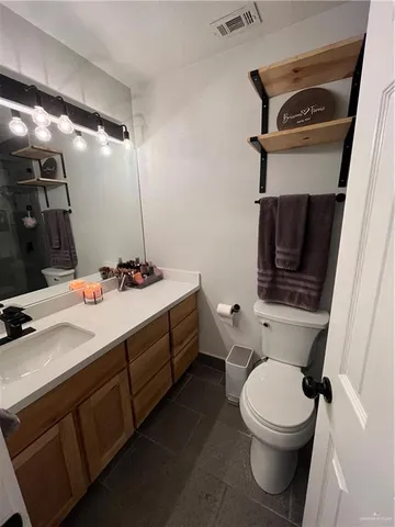 a bathroom with a sink a toilet and a mirror