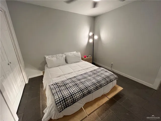 a bedroom with a bed and lamp with window