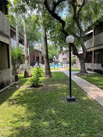 a front view of a house with garden and plants
