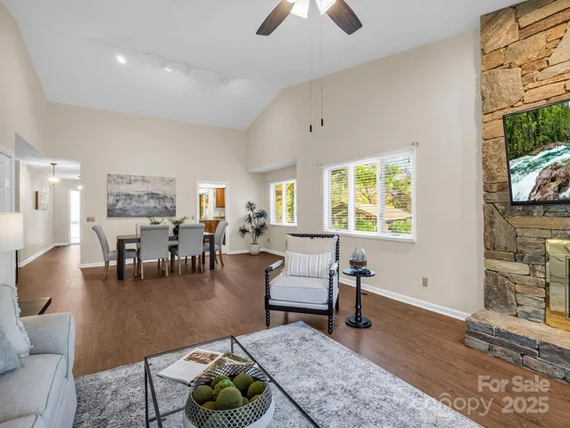 a living room with furniture a rug and a flat screen tv