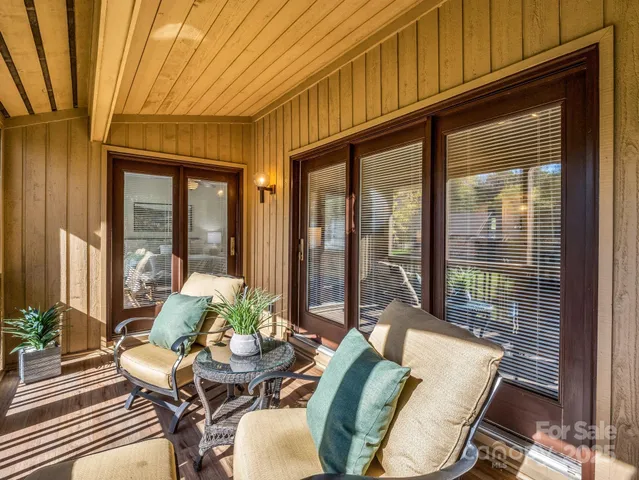 a balcony with furniture and wooden floor
