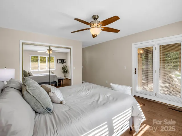 a bedroom with a large bed and a large window