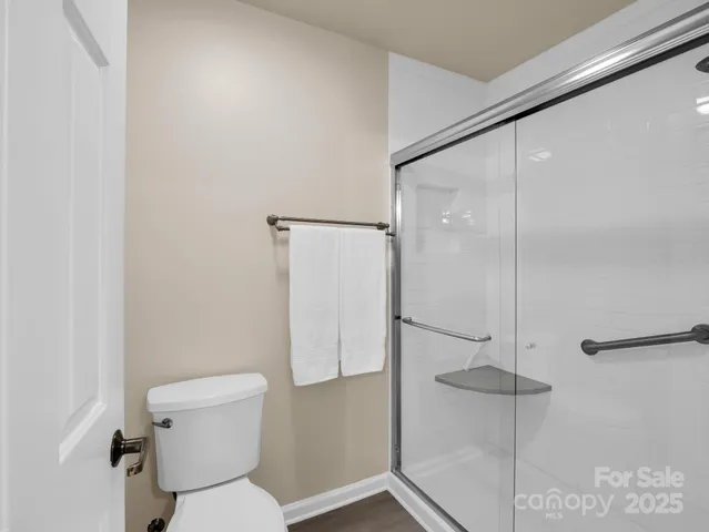 a bathroom with a toilet and a shower